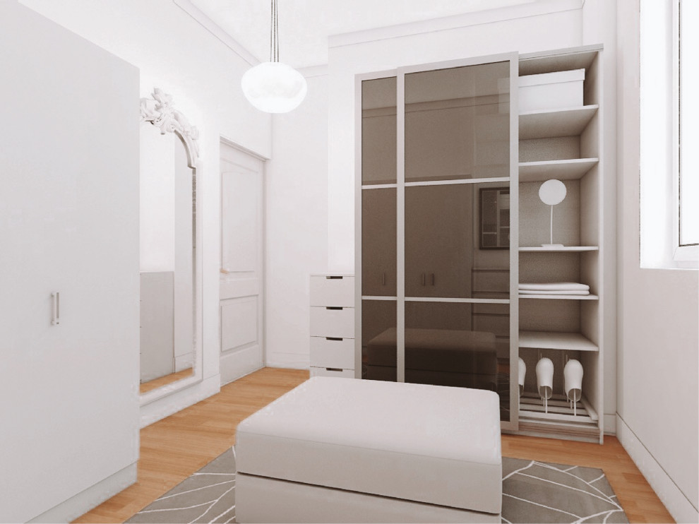 This is an example of a small classic walk-in wardrobe for women in Madrid with shaker cabinets, light wood cabinets, medium hardwood flooring, brown floors and a drop ceiling.