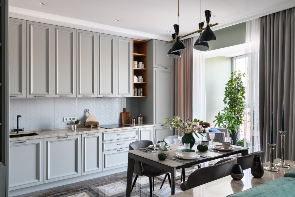 This is an example of a contemporary l-shaped open plan kitchen in Novosibirsk with an integrated sink, raised-panel cabinets, grey cabinets, solid surface benchtops, grey splashback, glass sheet splashback, black appliances, porcelain floors, no island, brown floor and beige benchtop.
