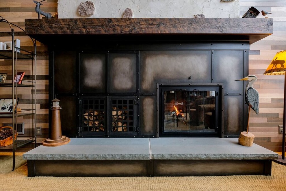 Inspiration for a mid-sized traditional living room in Milwaukee with brown walls, carpet, a standard fireplace, a metal fireplace surround and beige floor.