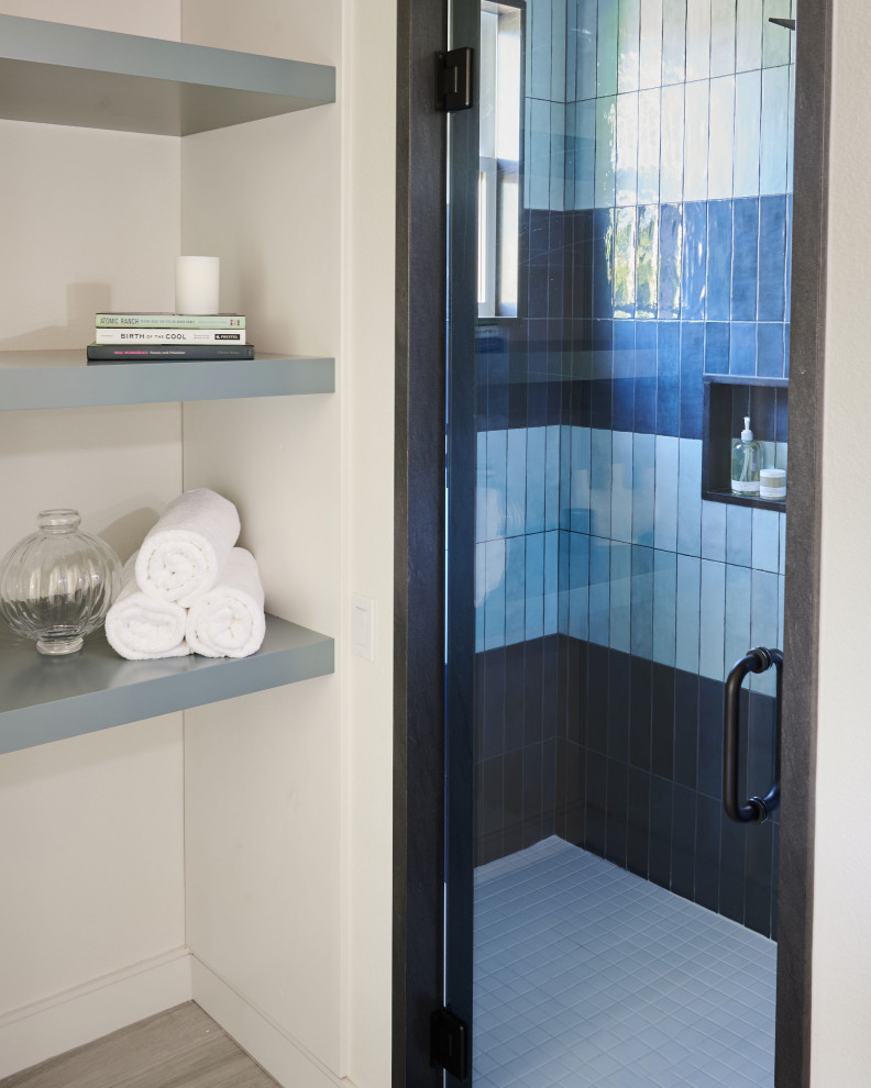 Example of a mid-sized minimalist 3/4 blue tile and ceramic tile wood-look tile floor, gray floor and single-sink bathroom design in Other with shaker cabinets, blue cabinets, a one-piece toilet, white walls, an undermount sink, granite countertops, a hinged shower door, blue countertops and a floating vanity