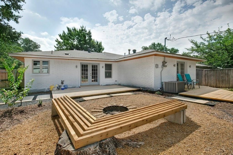 Midcentury backyard patio in Dallas with decking and no cover.