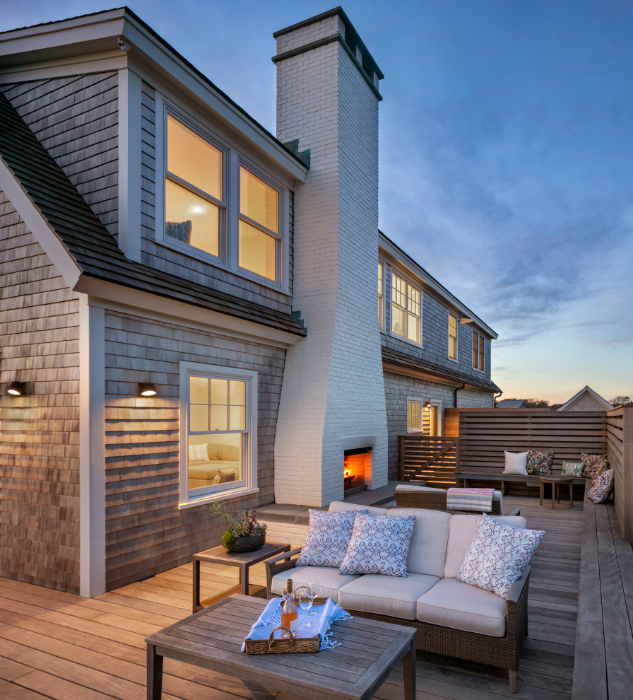 Mid-sized beach style two-storey grey house exterior in Providence with wood siding, a shingle roof and shingle siding.