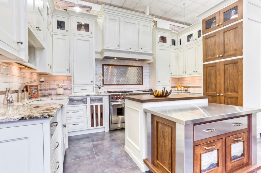 Large transitional u-shaped porcelain tile eat-in kitchen photo in Toronto with a farmhouse sink, beaded inset cabinets, white cabinets, granite countertops, white backsplash, subway tile backsplash, stainless steel appliances and an island