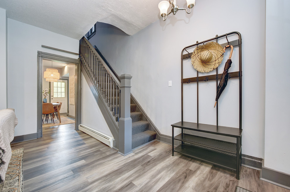 Foyer - mid-sized transitional gray floor foyer idea with gray walls