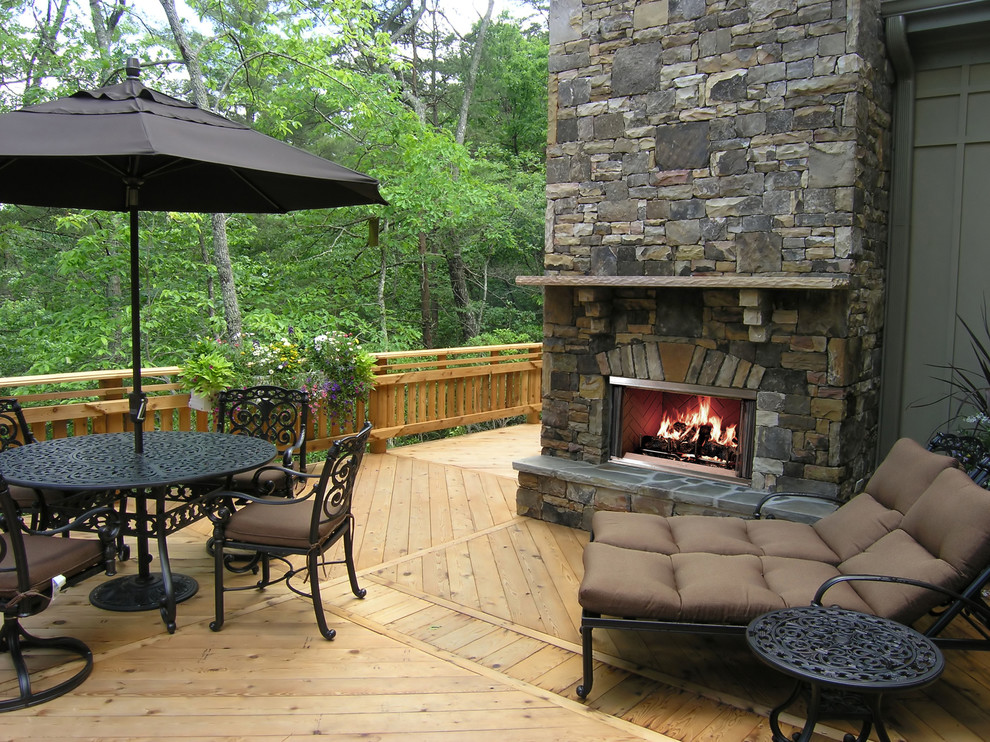 Photo of a mid-sized backyard patio in Boston with a fire feature, natural stone pavers and a roof extension.