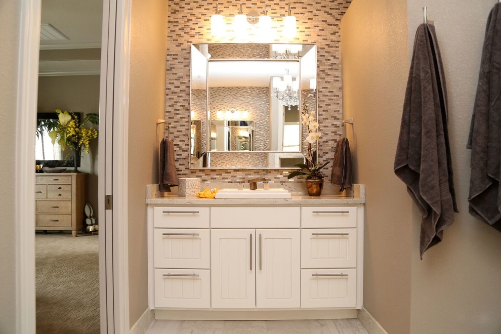 This is an example of a mid-sized transitional master bathroom with louvered cabinets, white cabinets, black and white tile, gray tile, matchstick tile, beige walls, a drop-in sink, granite benchtops, a freestanding tub, an alcove shower, a two-piece toilet and porcelain floors.