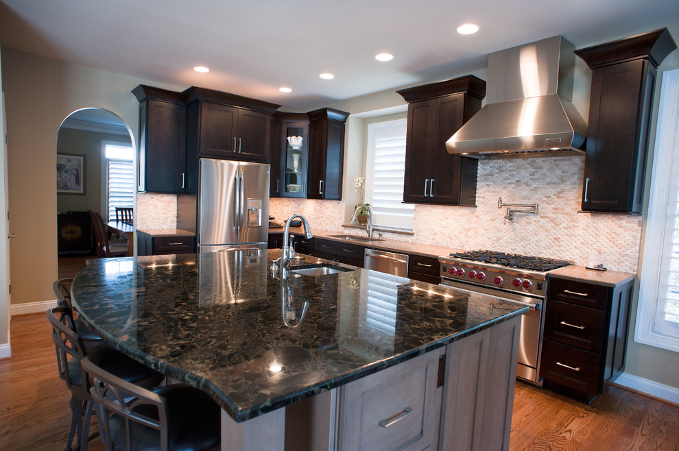 Example of a mid-sized transitional l-shaped kitchen design in Charlotte with dark wood cabinets, granite countertops, white backsplash and an island