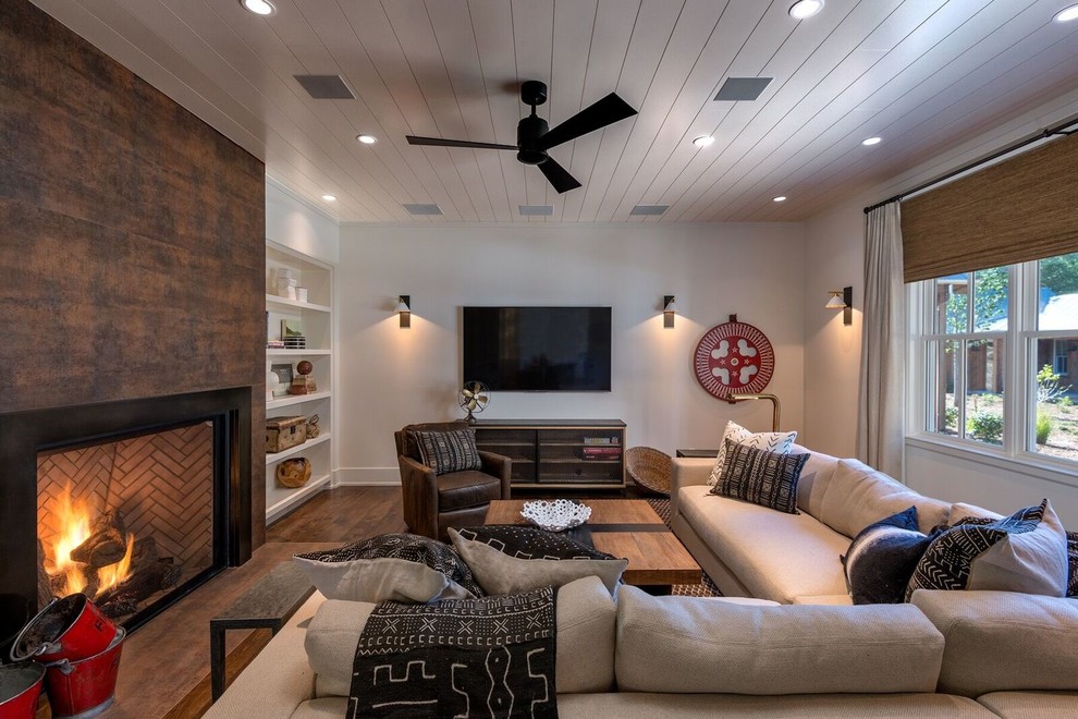 Family room - large traditional enclosed dark wood floor and brown floor family room idea in San Francisco with white walls, a standard fireplace, a concrete fireplace and a wall-mounted tv