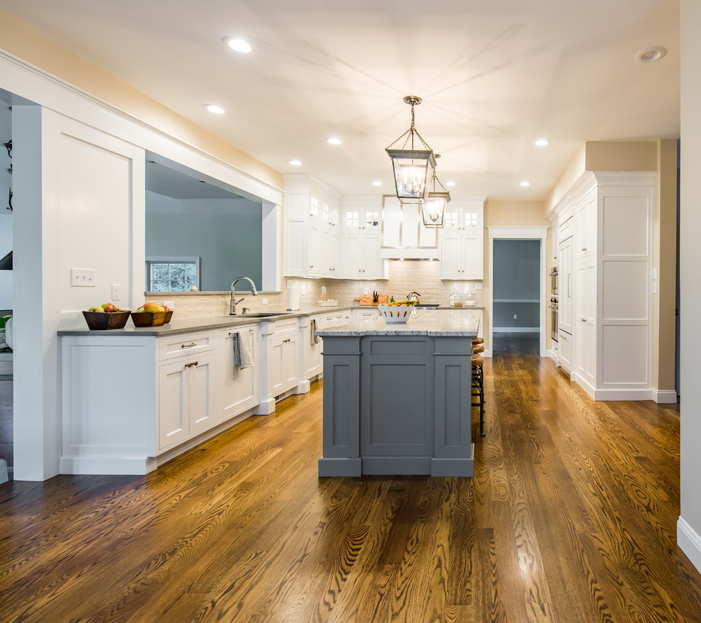Photo of a mid-sized traditional u-shaped separate kitchen in Boston with an undermount sink, shaker cabinets, stainless steel appliances, dark hardwood floors, with island, white cabinets, granite benchtops, beige splashback and porcelain splashback.