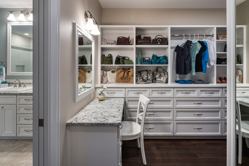 Photo of a large arts and crafts gender-neutral dressing room in Other with recessed-panel cabinets, white cabinets, dark hardwood floors and brown floor.