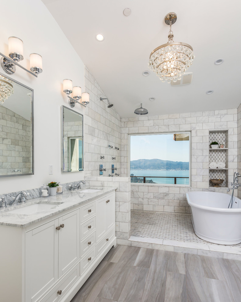 Master bathroom in San Francisco with shaker cabinets, white cabinets, a freestanding tub, a double shower, gray tile, subway tile, white walls, an undermount sink, grey floor, an open shower and grey benchtops.