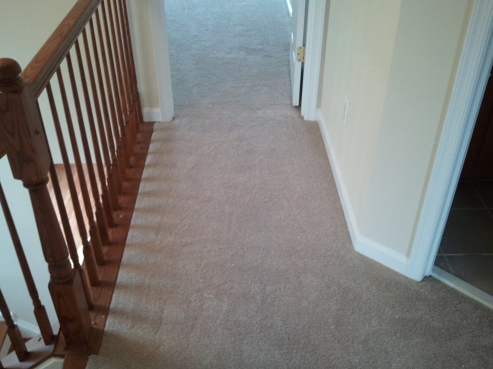 Inspiration for a small carpeted hallway remodel with beige walls