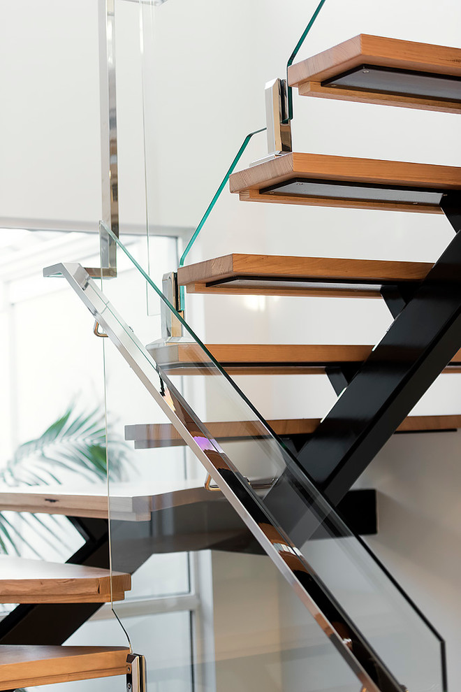 This is an example of a mid-sized modern wood u-shaped staircase in Perth with open risers.