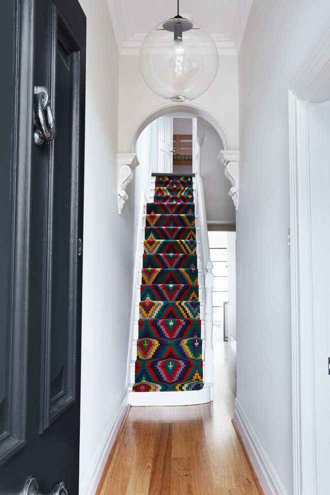 This is an example of a traditional painted wood straight staircase in Melbourne with painted wood risers.