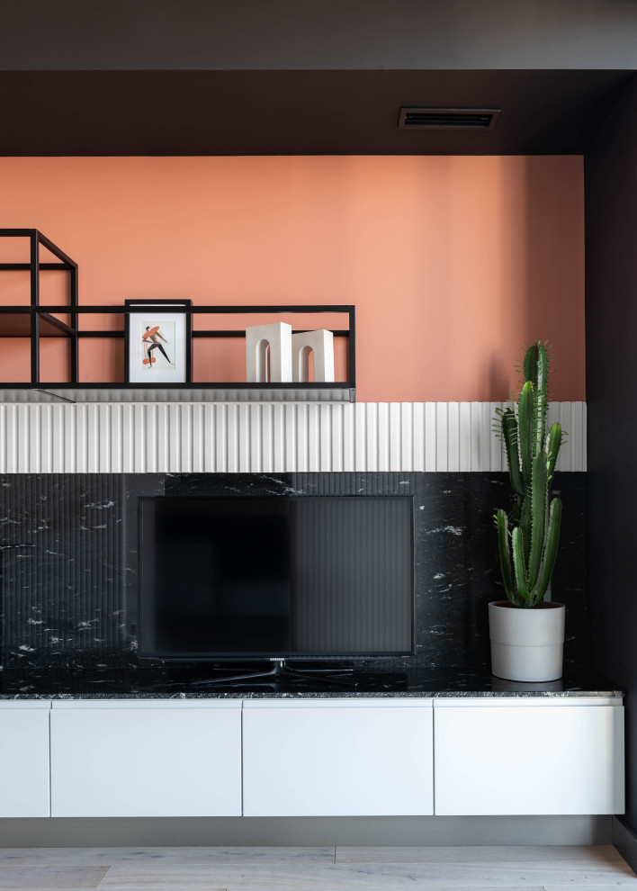 This is an example of a small scandinavian single-wall eat-in kitchen in Moscow with an undermount sink, flat-panel cabinets, white cabinets, granite benchtops, black splashback, granite splashback, black appliances, with island and black benchtop.