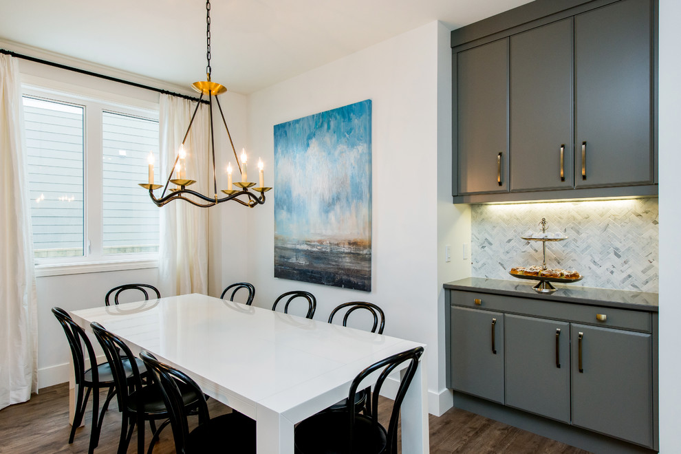 Inspiration for a transitional dark wood floor kitchen/dining room combo remodel in Calgary with flat-panel cabinets, gray cabinets, quartz countertops, multicolored backsplash, mosaic tile backsplash, stainless steel appliances, an island and an undermount sink