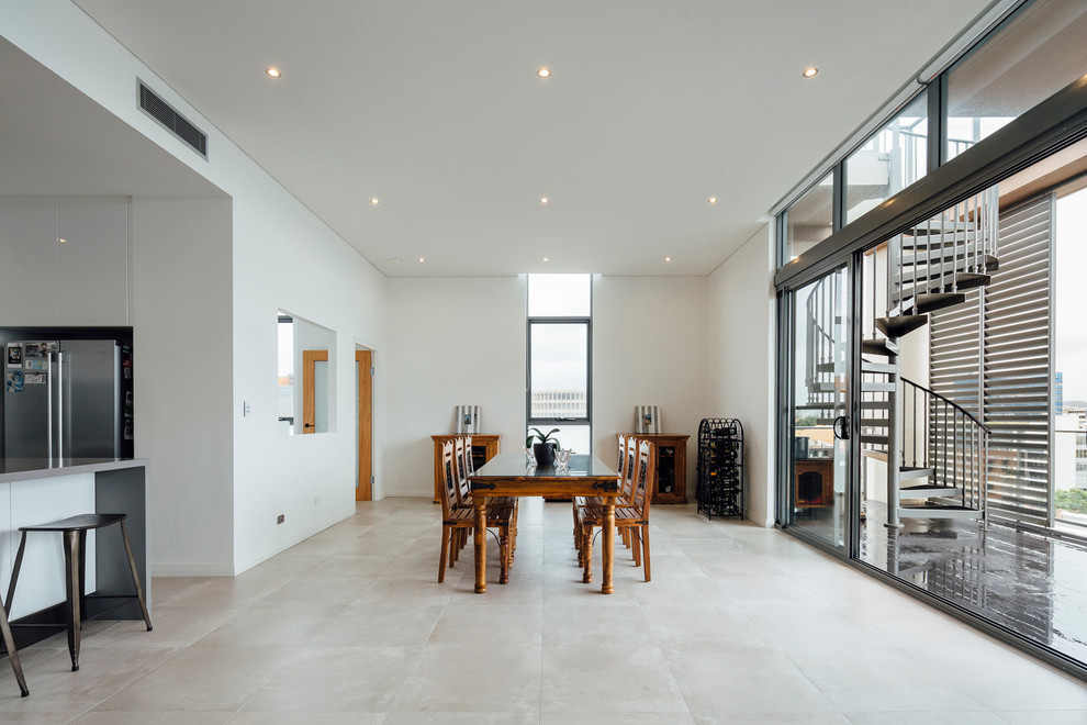 This is an example of a mid-sized scandinavian open plan dining in Newcastle - Maitland with white walls and concrete floors.