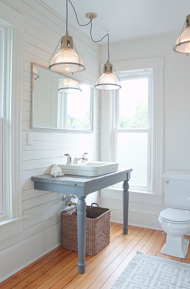 Design ideas for a large country master bathroom in Portland with furniture-like cabinets, grey cabinets, an alcove shower, a two-piece toilet, multi-coloured tile, porcelain tile, white walls, medium hardwood floors, a vessel sink and a shower curtain.