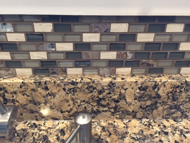 Inspiration for a mid-sized transitional u-shaped porcelain tile eat-in kitchen remodel in Boston with an undermount sink, recessed-panel cabinets, white cabinets, granite countertops, multicolored backsplash, mosaic tile backsplash, white appliances and a peninsula