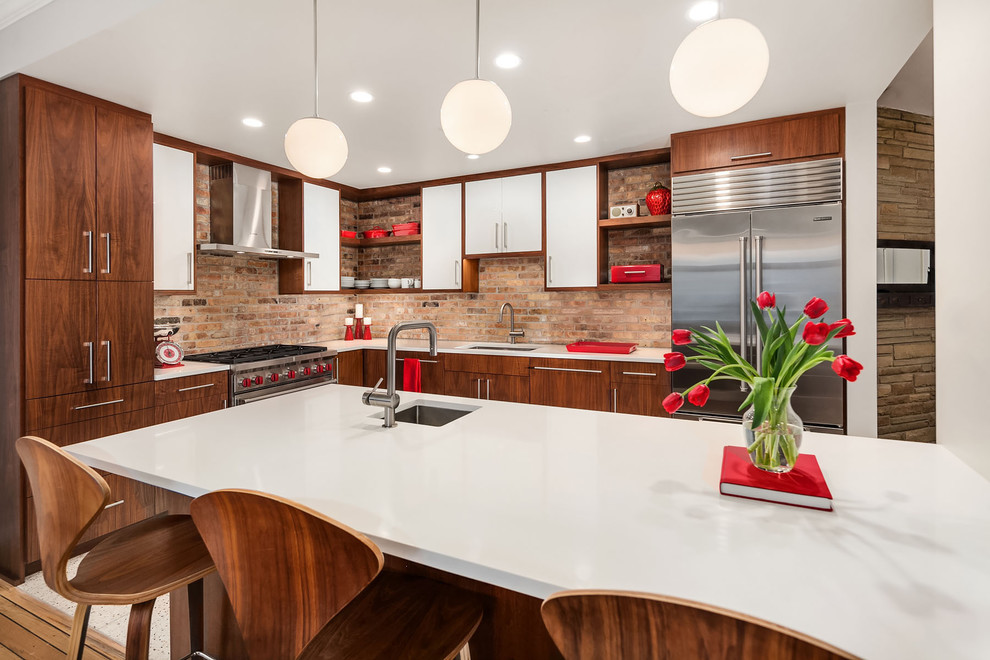 Design ideas for a mid-sized midcentury l-shaped eat-in kitchen in Chicago with an undermount sink, flat-panel cabinets, white cabinets, quartz benchtops, brown splashback, brick splashback, stainless steel appliances, terrazzo floors, with island and beige floor.