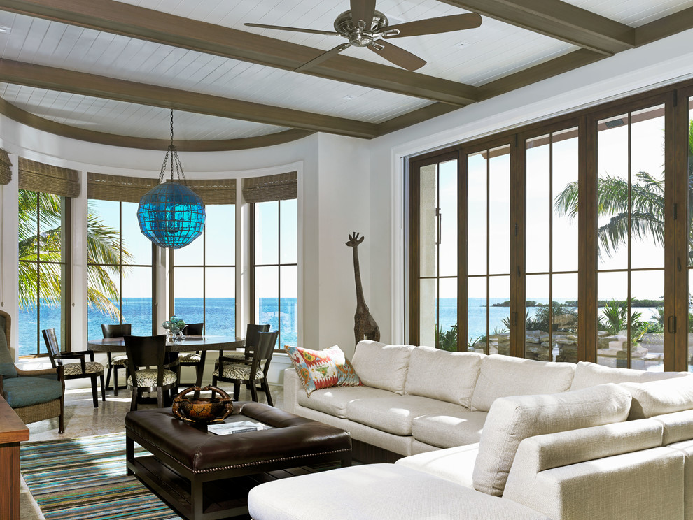 Photo of a tropical formal open concept living room in Miami with white walls and no fireplace.
