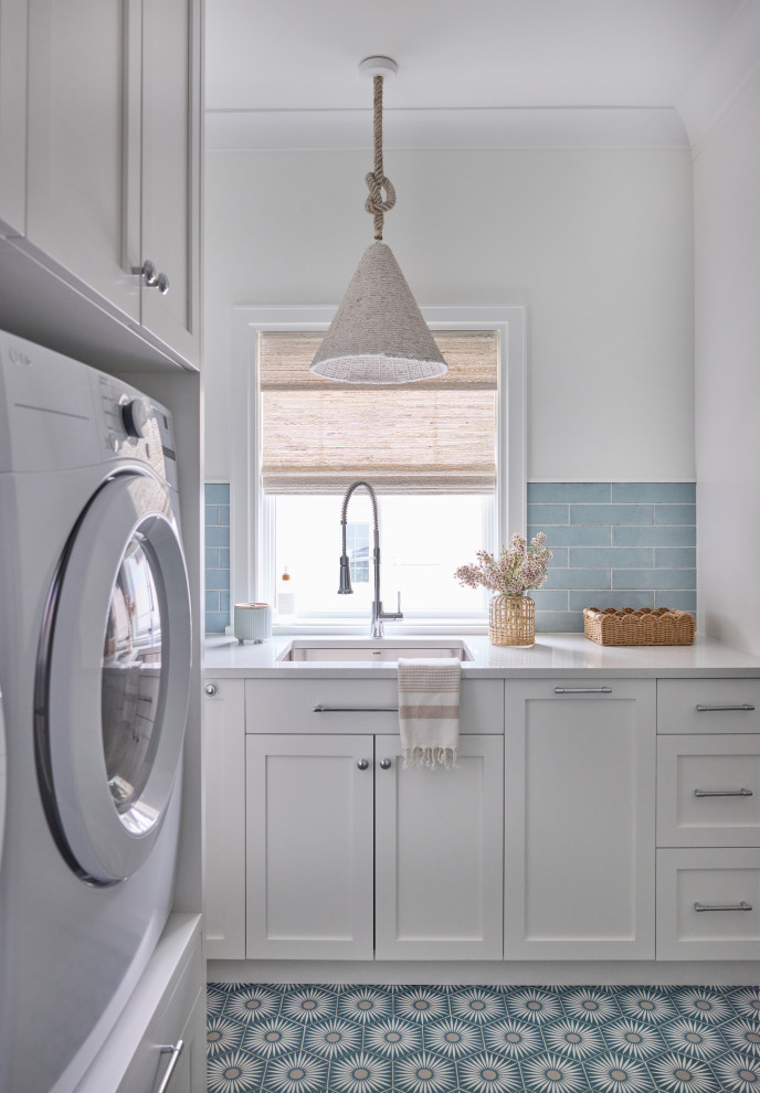 2 Chicks Happy Family Home - Coastal Laundry Room with Patterned Cement Tile Floor. A hardworking second laundry room in a Ponte Vedra Beach custom home by 2 Chicks Design Co. Blue subway tile, a patterned cement tile floor, a deep utility sink, woven pendant light, and woven wood shades create a coastal transitional laundry that earns its square footage.
Tags: Laundry Room, Mudroom, Cement Tile, Patterned Tile, Subway Tile, Utility Sink