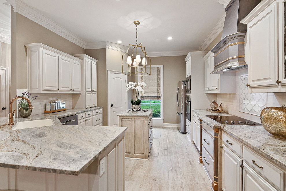 Mid-sized transitional u-shaped porcelain tile and gray floor eat-in kitchen photo with an undermount sink, raised-panel cabinets, white cabinets, granite countertops, white backsplash, marble backsplash, stainless steel appliances, an island and multicolored countertops