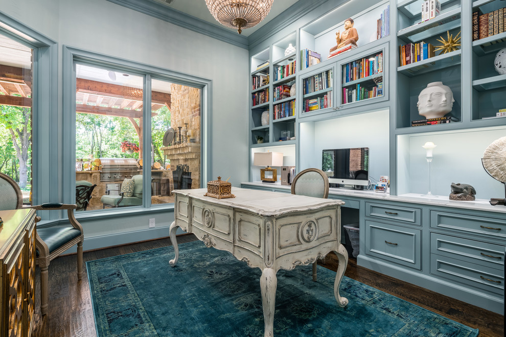 This is an example of a large eclectic study room in Dallas with blue walls, dark hardwood floors, no fireplace, a freestanding desk, brown floor and vaulted.