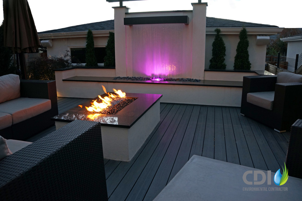 Small mediterranean backyard deck in Denver with a fire feature and no cover.