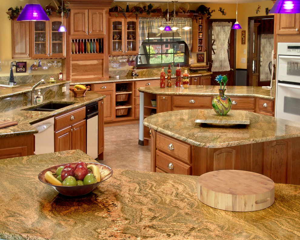 Inspiration for a large traditional kitchen in Miami with a double-bowl sink, raised-panel cabinets, light wood cabinets, granite benchtops, travertine floors and with island.