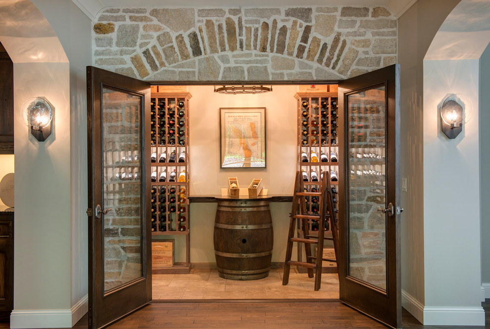 Design ideas for a mid-sized mediterranean wine cellar in Minneapolis with limestone floors and storage racks.