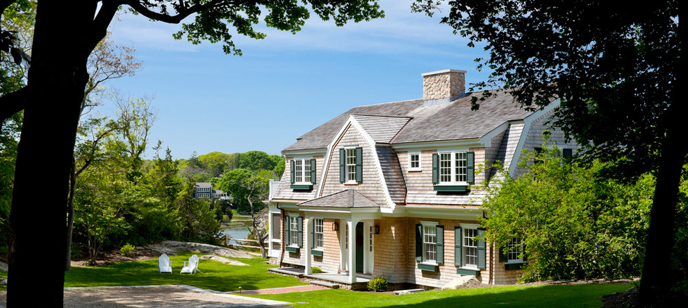 This is an example of a mid-sized traditional three-storey exterior in Boston with wood siding and a gambrel roof.