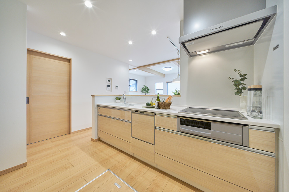 Photo of a scandinavian kitchen in Other with beige cabinets, plywood floors, beige floor and beige benchtop.