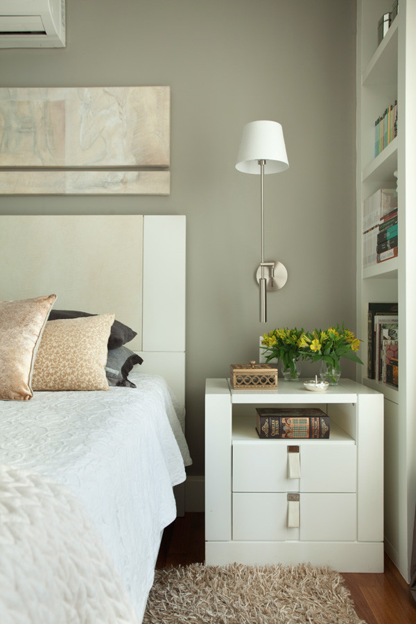 Photo of a mid-sized contemporary master bedroom in Other with grey walls and light hardwood floors.
