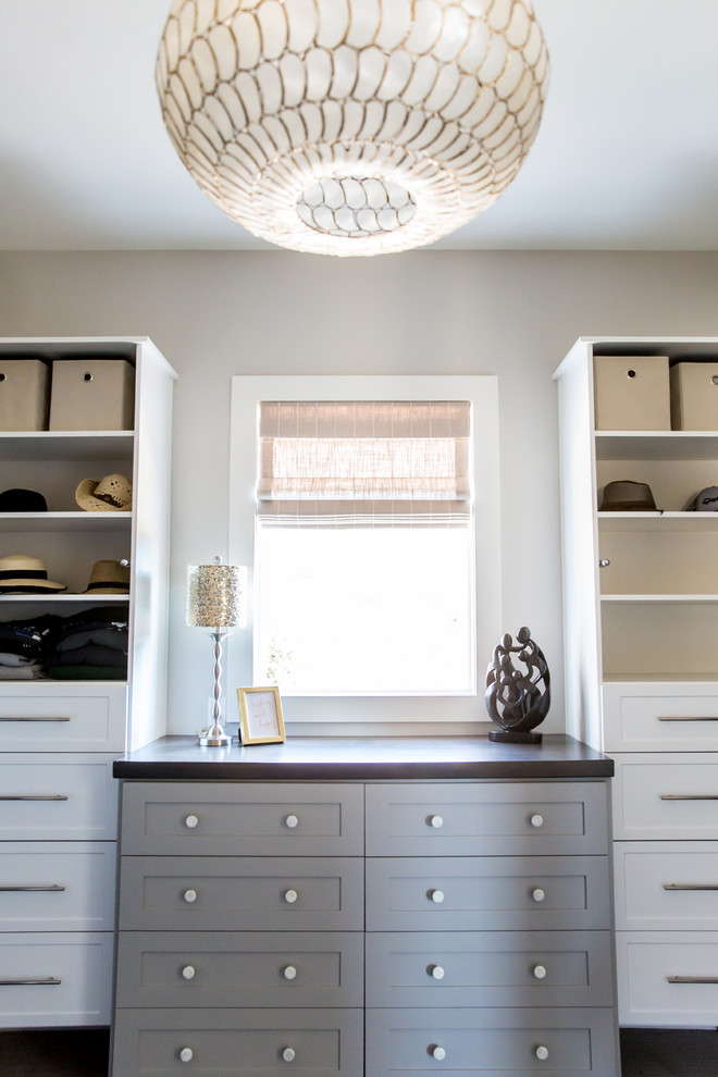 Photo of a large transitional gender-neutral walk-in wardrobe in Salt Lake City with shaker cabinets, white cabinets and carpet.