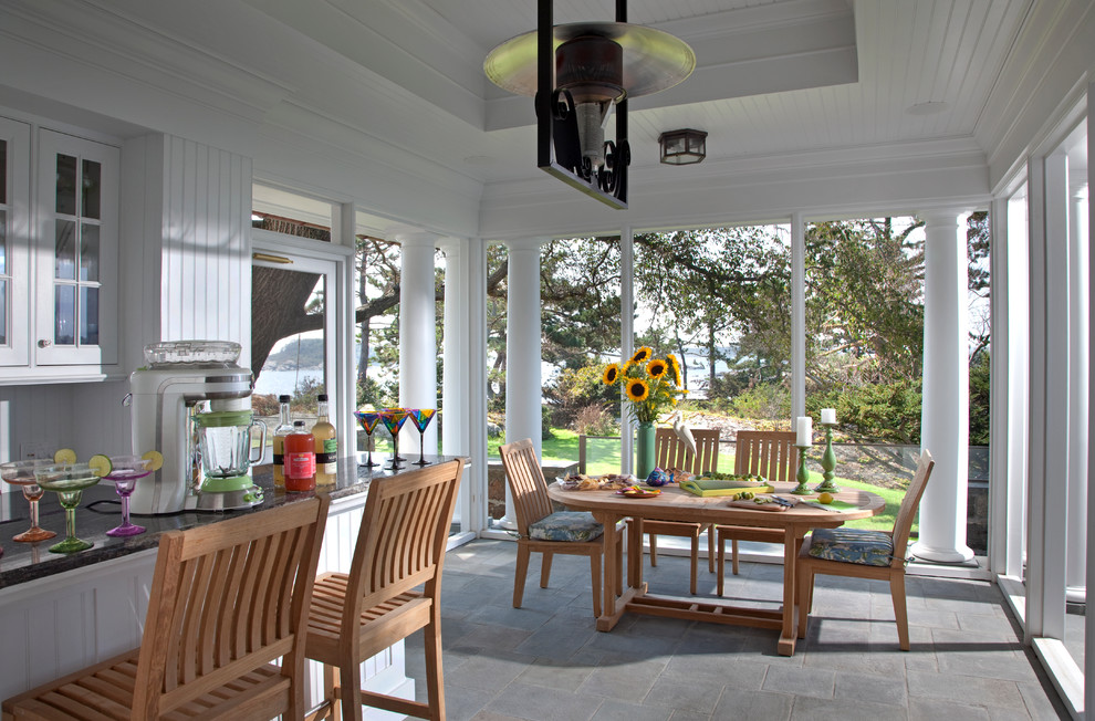 Inspiration for a traditional verandah in Boston with an outdoor kitchen, stamped concrete and a roof extension.