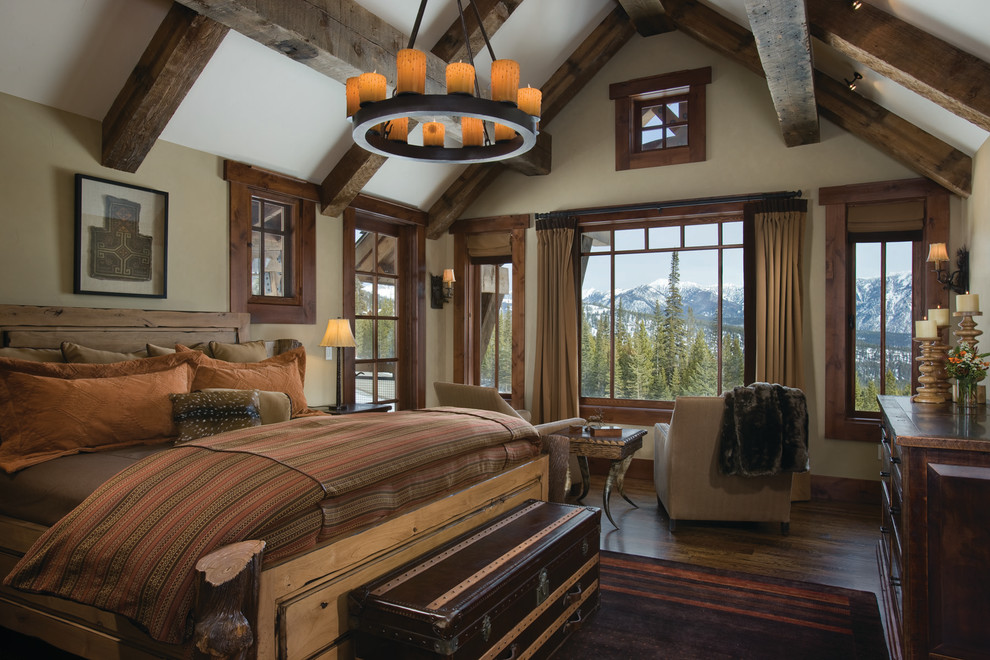 Photo of a country bedroom in Other with beige walls and dark hardwood floors.