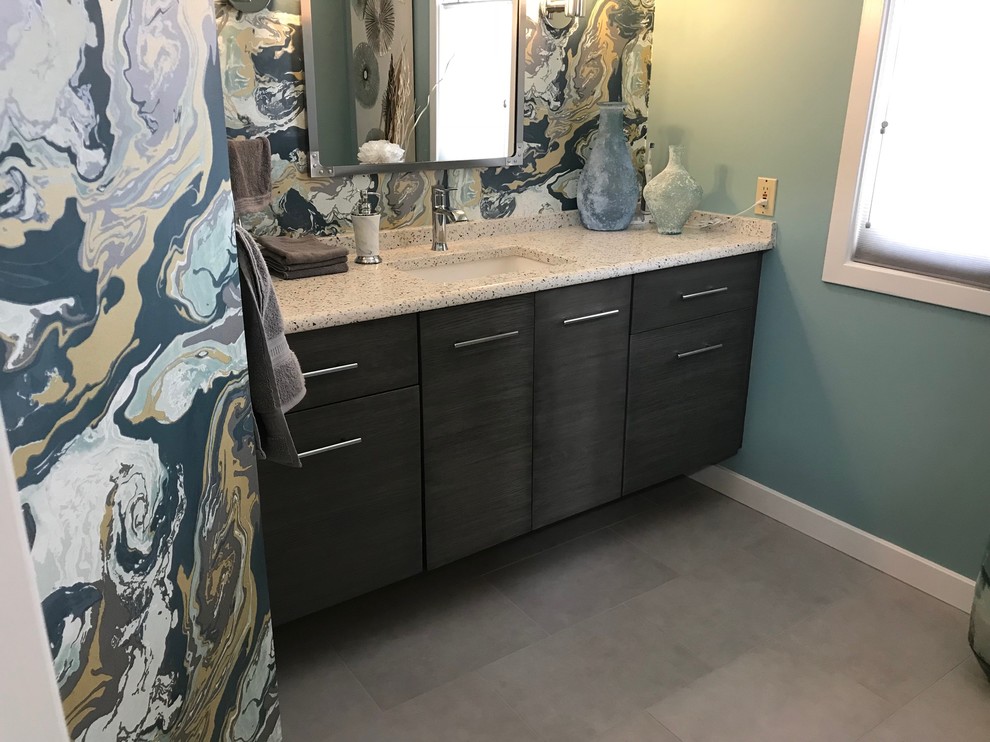 Inspiration for a small contemporary powder room in Other with flat-panel cabinets, grey cabinets, a one-piece toilet, gray tile, blue walls, porcelain floors, an undermount sink, recycled glass benchtops and grey floor.