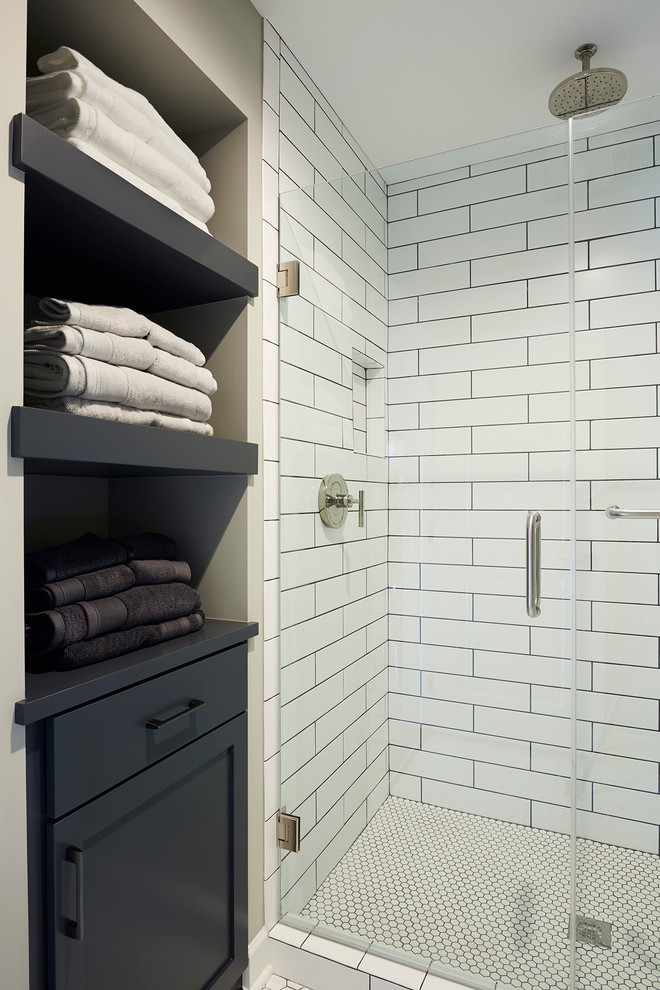 Inspiration for a small transitional 3/4 bathroom in Minneapolis with furniture-like cabinets, distressed cabinets, an alcove shower, a two-piece toilet, white tile, glass tile, grey walls, mosaic tile floors and a vessel sink.