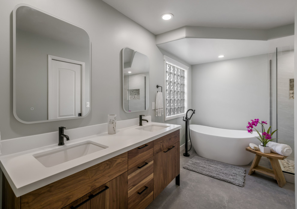Large transitional master bathroom in Phoenix with flat-panel cabinets, light wood cabinets, a freestanding tub, an alcove shower, white tile, porcelain tile, an undermount sink, engineered quartz benchtops, grey floor, a hinged shower door, white benchtops, a niche, a double vanity, a freestanding vanity, white walls and porcelain floors.