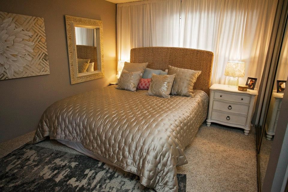 Photo of a small beach style master bedroom in San Diego with beige walls and carpet.