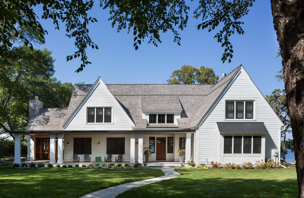 Mid-sized traditional two-storey white house exterior in Minneapolis with a gable roof, wood siding and a shingle roof.