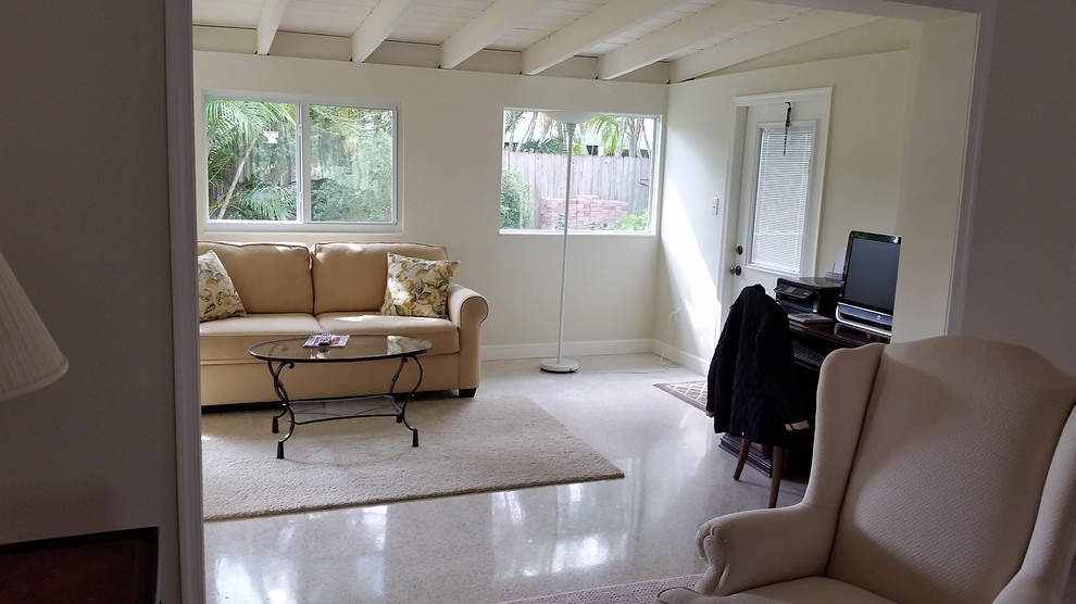 Design ideas for a small traditional enclosed family room in Miami with beige walls, concrete floors, a freestanding tv and multi-coloured floor.