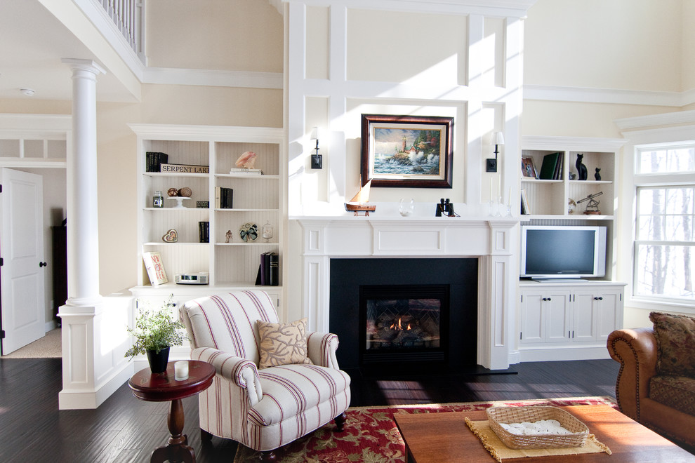 Inspiration for a traditional living room in Minneapolis with a standard fireplace, a built-in media wall and beige walls.