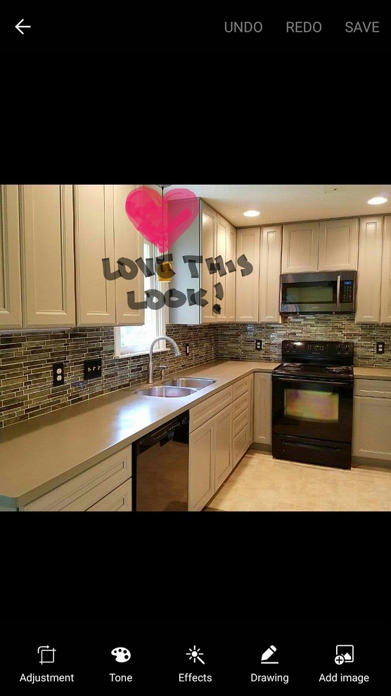 Inspiration for a mid-sized transitional kitchen remodel with a double-bowl sink, recessed-panel cabinets, gray cabinets, solid surface countertops, multicolored backsplash, glass tile backsplash and black appliances