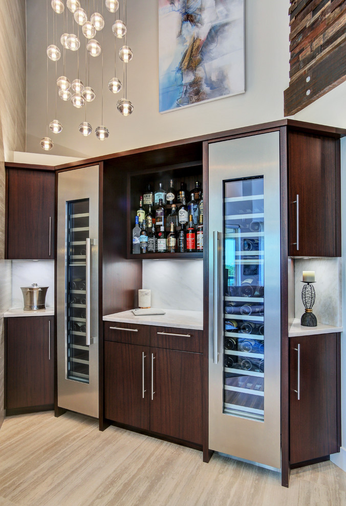 Inspiration for a mid-sized contemporary l-shaped wet bar in Tampa with flat-panel cabinets, dark wood cabinets, marble benchtops, white splashback, marble splashback, light hardwood floors, beige floor and white benchtop.