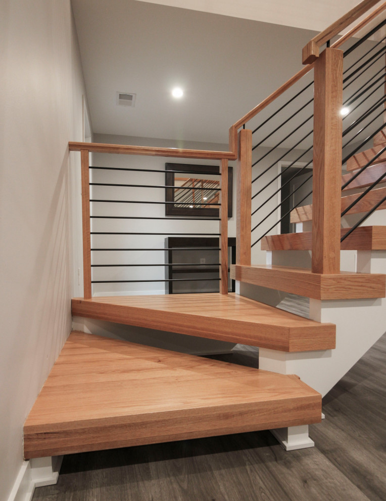 Exemple d'un petit escalier en L avec des marches en bois et un garde-corps en matériaux mixtes.