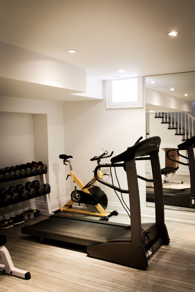 Inspiration for a small traditional multipurpose gym in Toronto with white walls and ceramic floors.