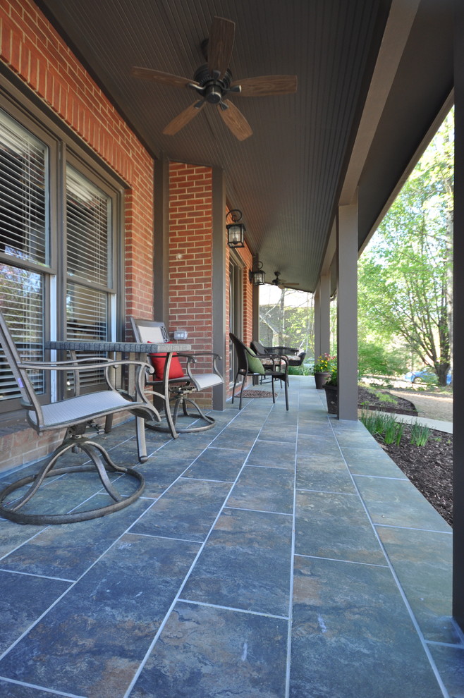 This is an example of a mid-sized contemporary front yard verandah in Atlanta with tile and a roof extension.