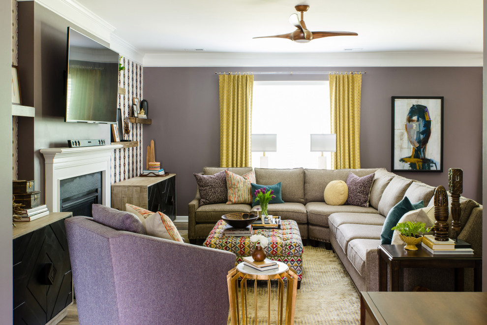 This is an example of a transitional living room in Charlotte with purple walls, dark hardwood floors, a standard fireplace, a wall-mounted tv and brown floor.